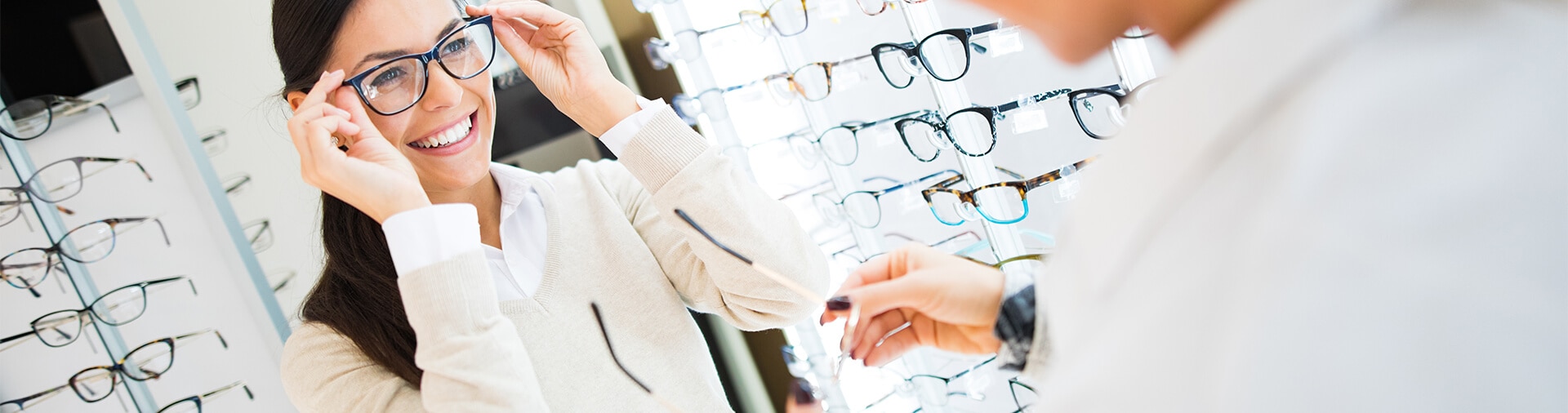 woman trying on glasses in an eye doctor's office