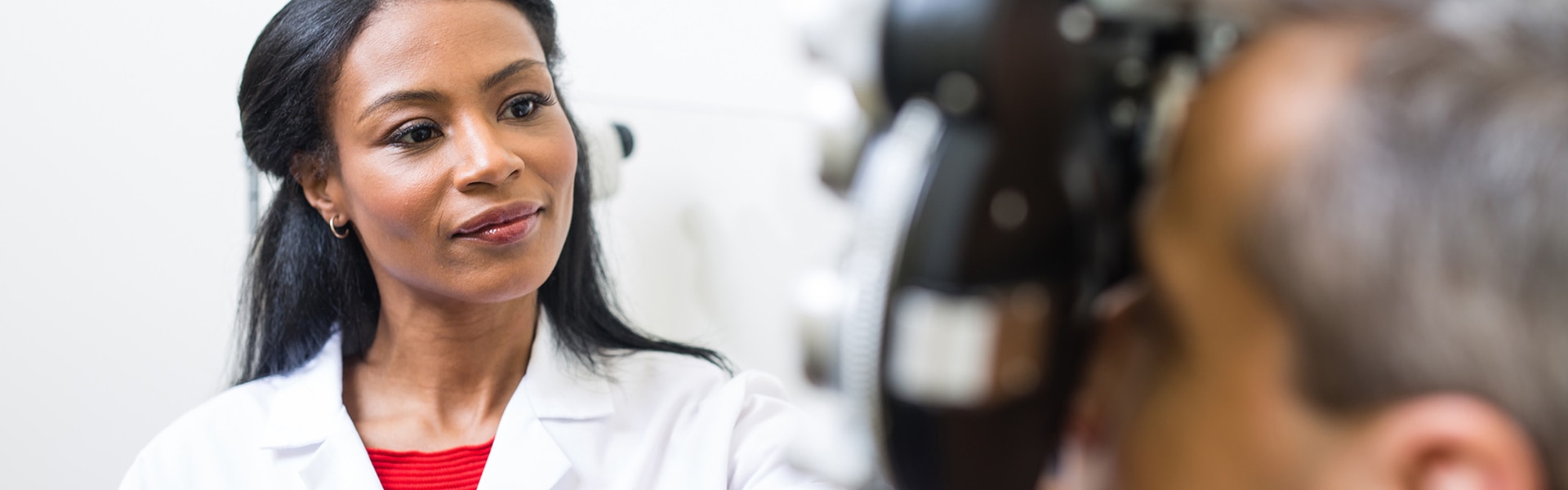 An optometrist examining a patient's eyes.