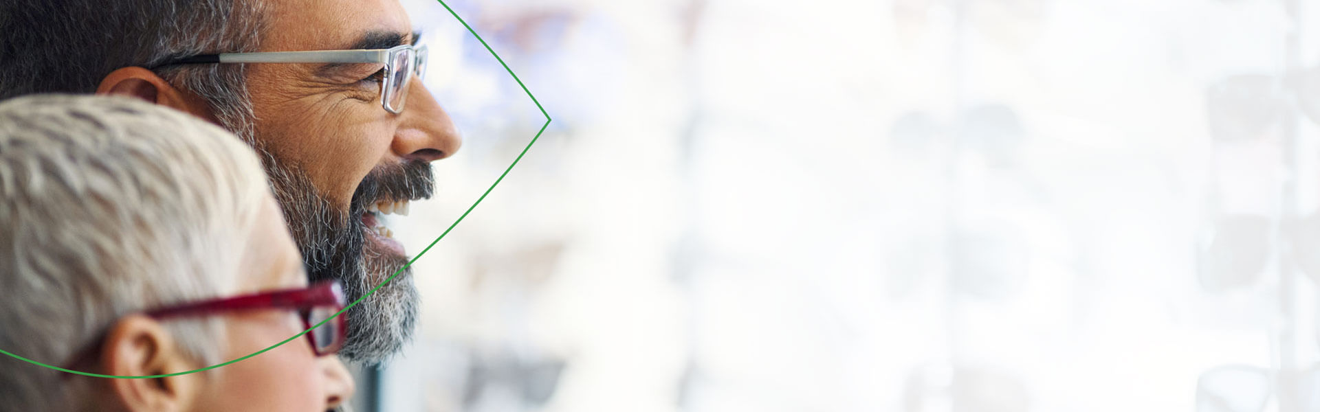 Man and woman smiling, wearing glasses.