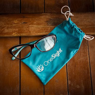 A pair of glasses and a carrying case with the OneSight logo.