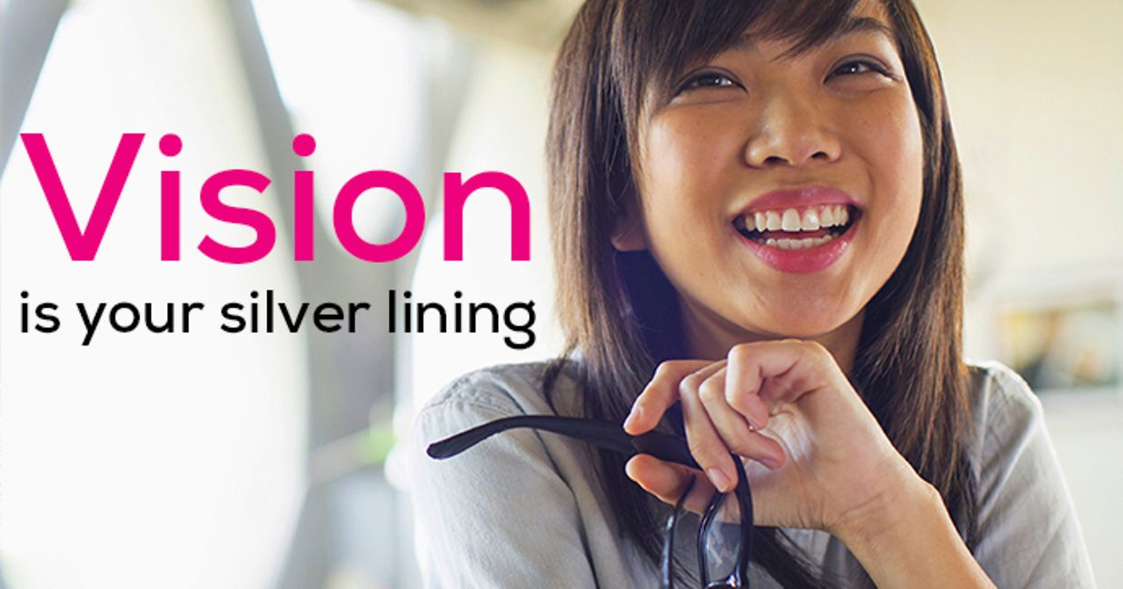 Young woman holding glasses and smiling. Text reads "Vision is your silver lining"