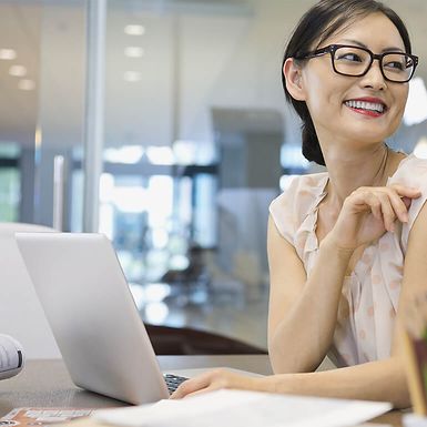 You woman using a computer in an office.